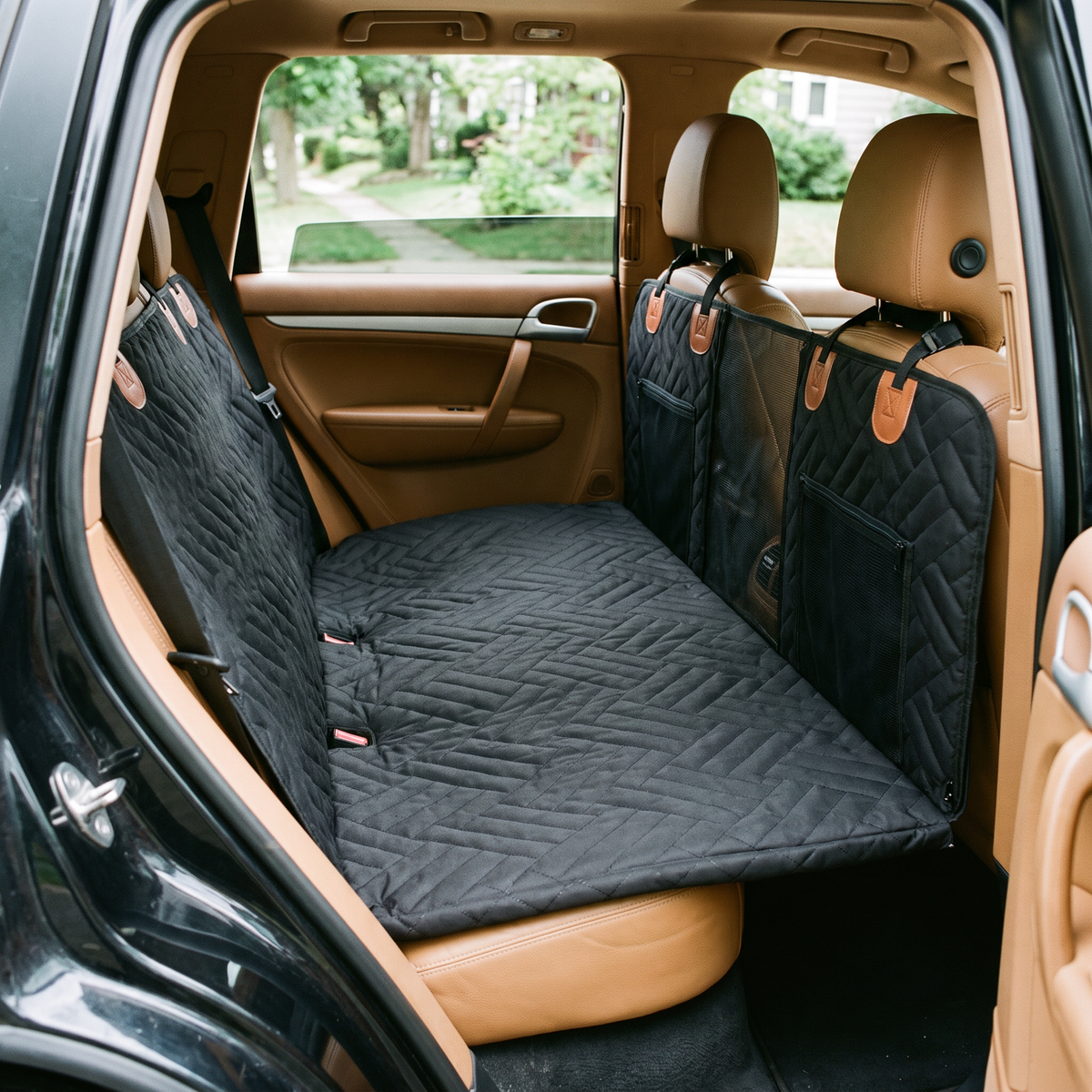 Voyager seat cover fitted across a car back seat forming a flat platform